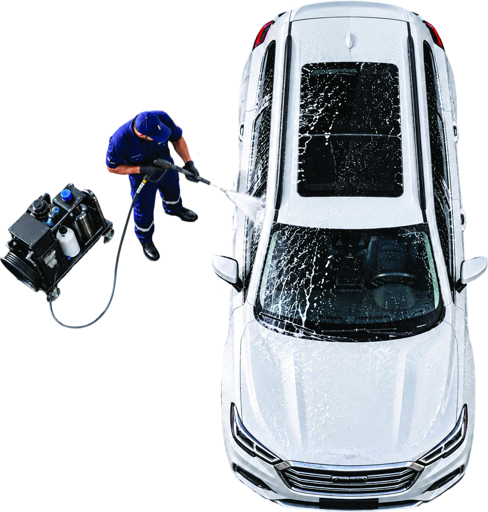 Technician operating a mobile pressure-wash unit on a vehicle